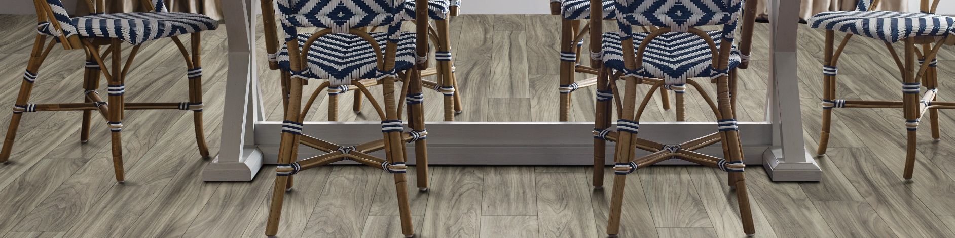 woven dining chairs around a dining table - Mac's Custom Flooring